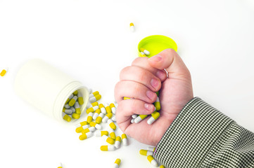 Man hand holds heap of colorful drug pills 