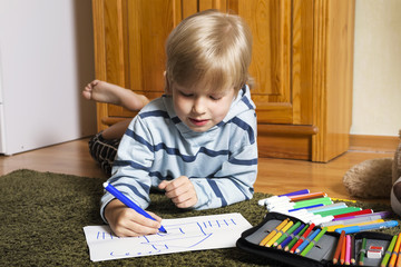 Boy draws a marker