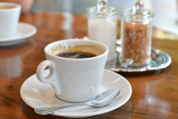 Coffee, refined sugar and unbleached sugar on the table
