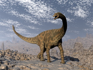 Obraz na płótnie Canvas Spinophorosaurus dinosaur walking in the desert - 3D render