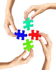 Red and blue puzzle in woman hands isolated on white