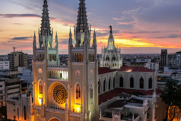 Scenic sunset sky with towers of illuminated Guayaquil Metropolitan Cathedral, Ecuador - obrazy, fototapety, plakaty