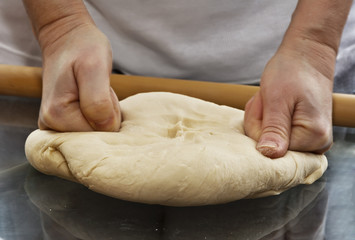Home made pasta, italian spaghetti, women making dough on table - preparing lunch 
