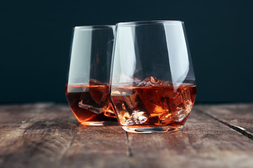 whiskey with ice on a wooden table