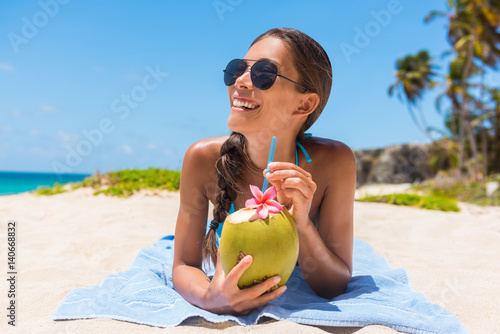 "Sunglasses beach woman drinking coconut water having fun