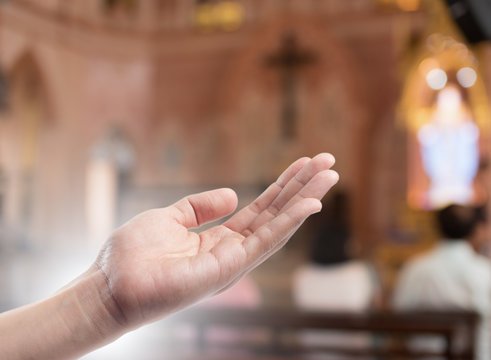 Human open empty hand with palms up(Praying Hand) on blurred church interior background
