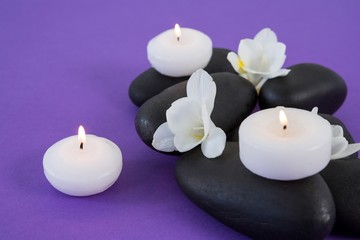 White flowers, candles on zen stone