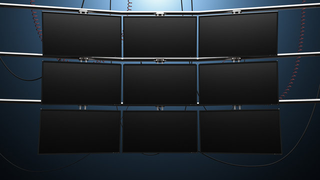 Nine Panel Video Monitor Wall. A Futuristic Nine Panel Video Wall With Blank Screens And Cords Mounted On Pipes