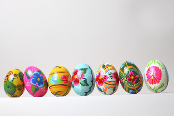 Easter eggs arranged in a row, on a white background