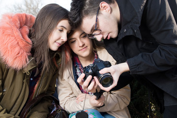Young photographer shows photos to the girls