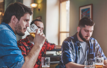 Group Of Hipster Friends Drinking Craft Beer, focus on Hipster