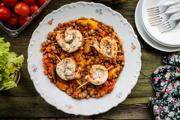 Fish rolls and lentils with vegetables in tomato sauce