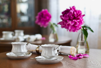 A cup of tea and napkin and peony
