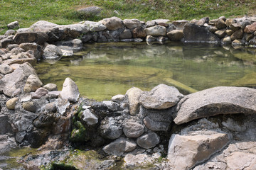Naklejka na ściany i meble Hot springs pool in nature