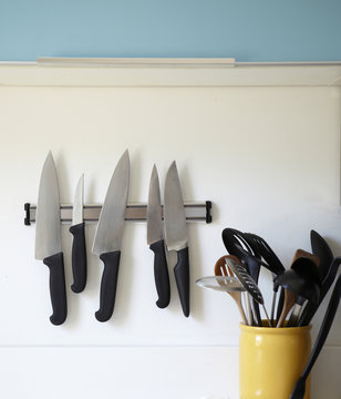 Knives on a magnetic strip in the kitchen.