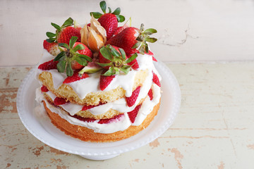Homemade cream layer cake, fresh, colorful, and delicious dessert with juicy strawberries, sweet whipped cream and cream cheese