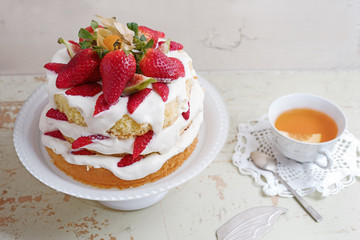 Homemade cream layer cake, fresh, colorful, and delicious dessert with juicy strawberries, sweet whipped cream and cream cheese