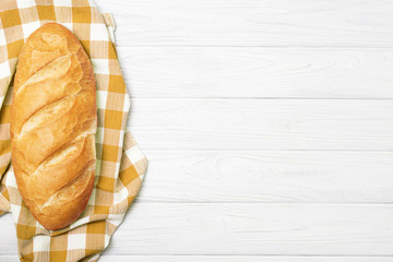 Fresh bread with napkin on kitchen table