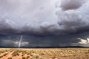 Lightning strike with dramatic storm clouds in the desert