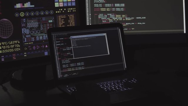 IT Programmer write code program on the laptop in dark room