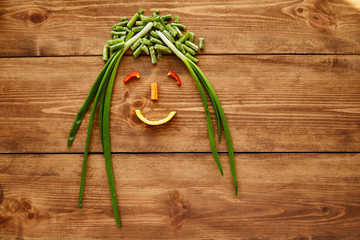 A smile from vegetables and fruits as a theme of a healthy lifestyle and healthy eating. Copy space, top view.