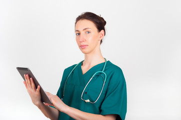 Portrait of young attractive doctor, surgeon, nurse with stethoscope and tablet