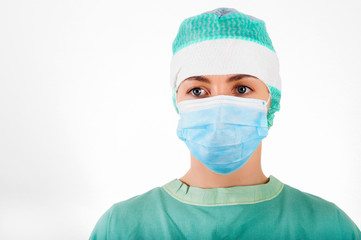Portrait of woman surgeon wearing surgical mask and cap