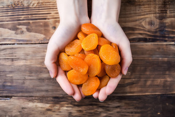 dried apricots in hands