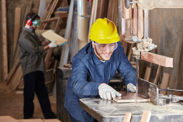 Handwerker sägt Holz an der Bandsäge