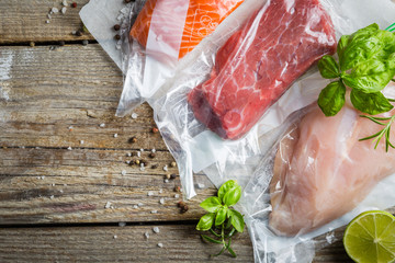 Beef, chicken and salmon in vacuum plastic bag for sous vide cooking - obrazy, fototapety, plakaty