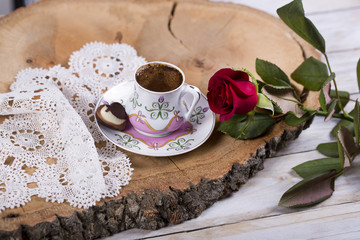 Turkish coffee with hearth shaped chocolate, red rose on the lace cover 