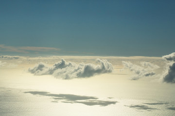 Fluffy white clouds on blue sky over idyllic sea