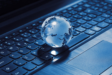  Crystal globe on laptop keyboard