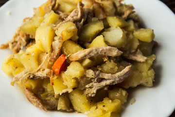 baked potatoes with meat, carrots and onions