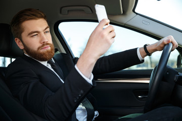Side view of calm business man making selfie