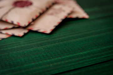 Old vintage retro envelopes with a wax stamp on old dark green wooden table