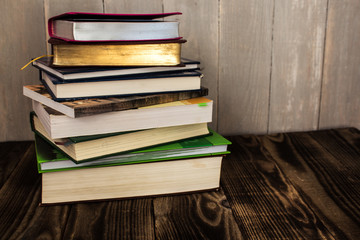stack of books on wooden background