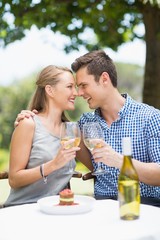 Couple toasting glasses of wine in a restaurant