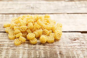 Heap of pasta on the brown wooden table