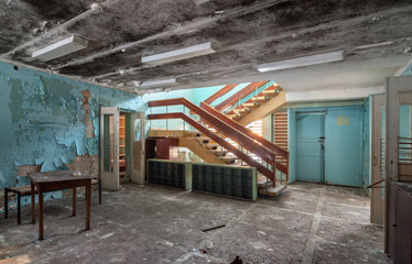 Hall with stairs in the abandoned building of the children's health camp