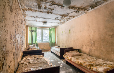 Fototapeta na wymiar Abandoned room with beds of children's health camp