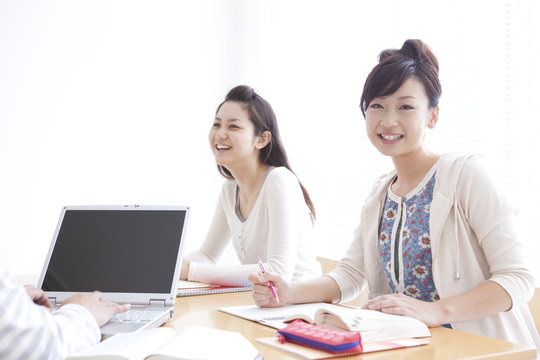 College students studying using laptop