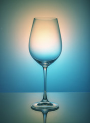 Wine glass on color background