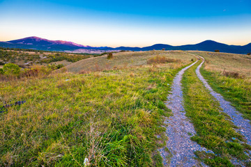 Country road in Lika region landscape