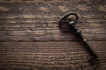 Vintage key on a wooden chocolate background 