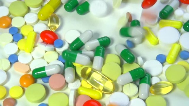 Medical pills falling down. Medicine concept. Treatment Many coloured capsules, pills. Full HD. Slow motion 240 fps. HD 1080p 