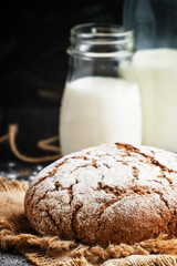Homemade rye bread and fresh milk, low key, selective focus