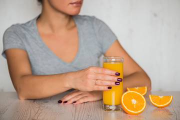 healthy drink, diet, detox and people concept - close up of woman with orange juice in glass