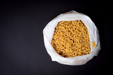 Macaroni pasta on black background