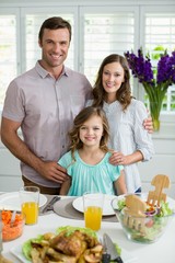 Portrait of smiling family having lunch together on dining table